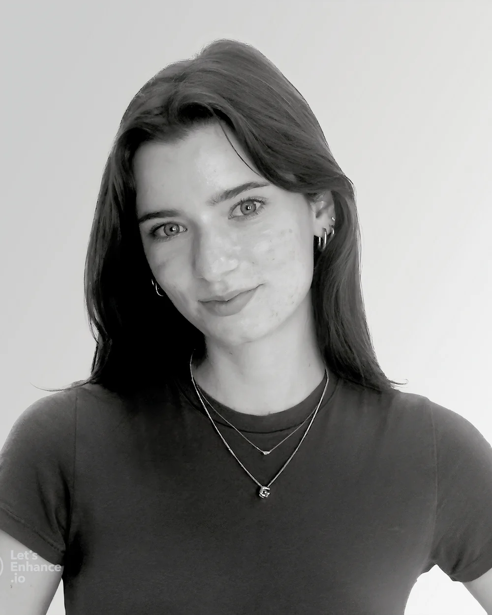Professional headshot of Grace Jermstad, smiling, with long brown hair against a soft blue background.