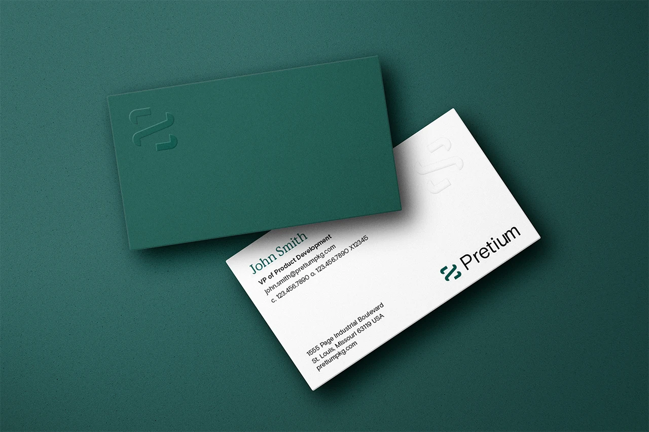 Embossed Pretium business card mockups — a deep green card with a debossed brandmark, and a white card with the green wordmark and John Smith's contact details.